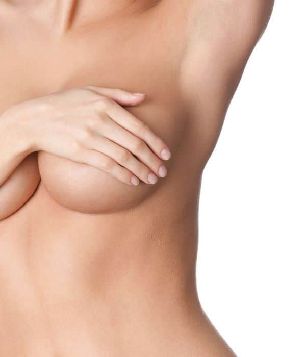 picture of woman covering her breasts