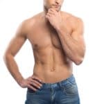 Handsome young man in blue jeans with naked torso
