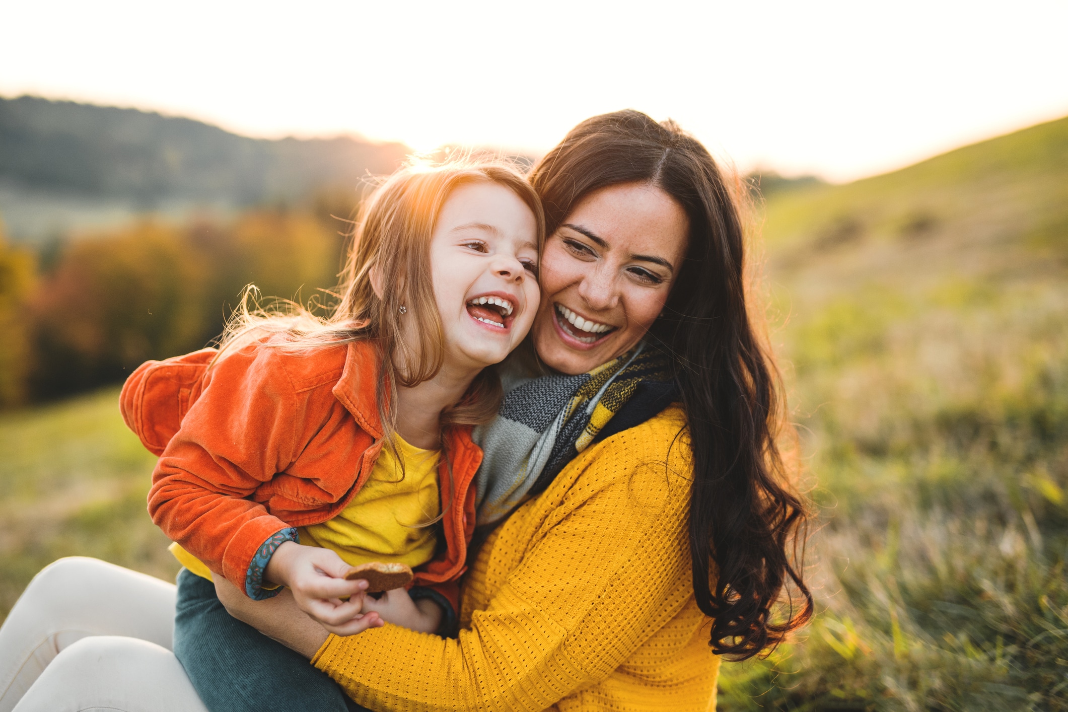 Mother holding child after Mommy Makeover