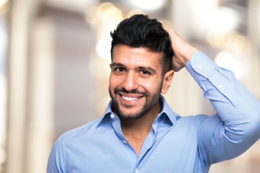 Portrait,Of,A,Man,Touching,His,Hair Hair Restoration in Gainesville, FL