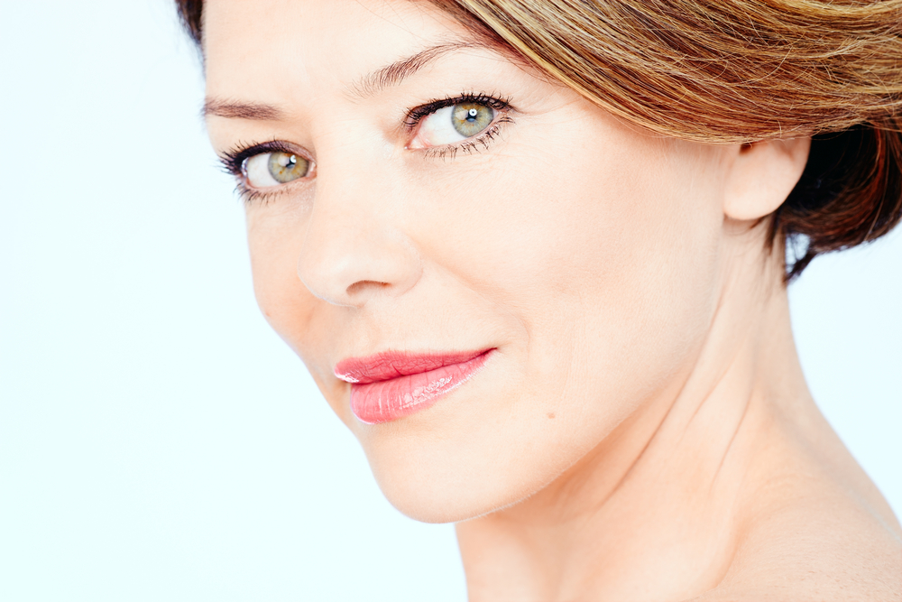 Middle aged woman restores volume to her lips in a natural-looking way.